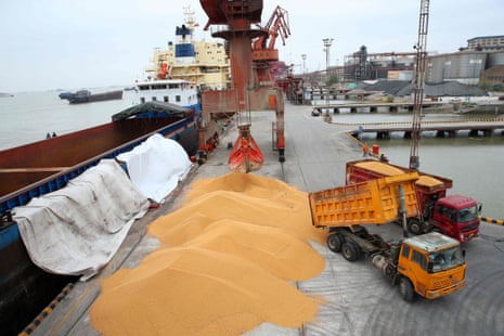 Workers loading imported soybeans onto trucks at a port in Nantong in China’s eastern Jiangsu province.