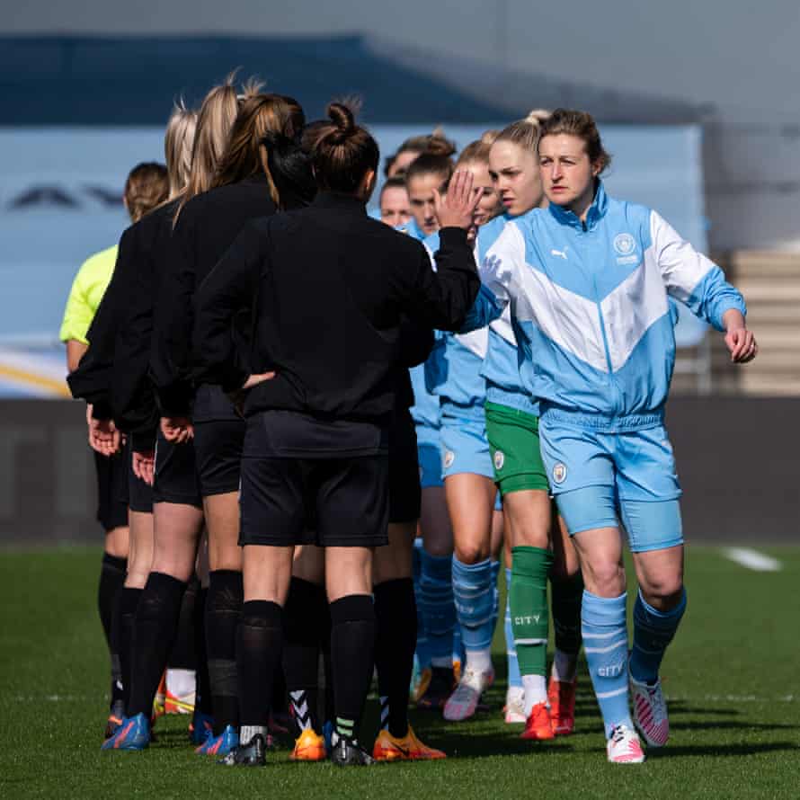 Manchester City's captain Ellen White (right) leads the pre-match handshake.