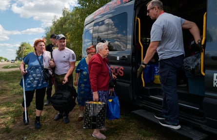 Older people being helped into a minibus