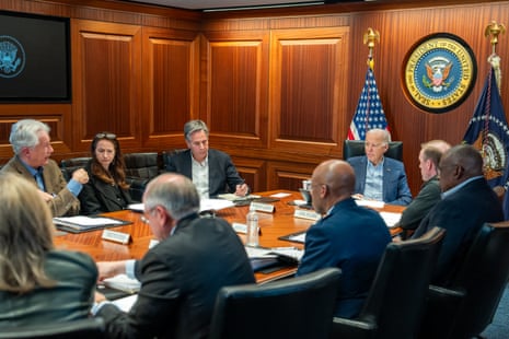 Biden and his security team meet in a White House briefing room at a conference table.