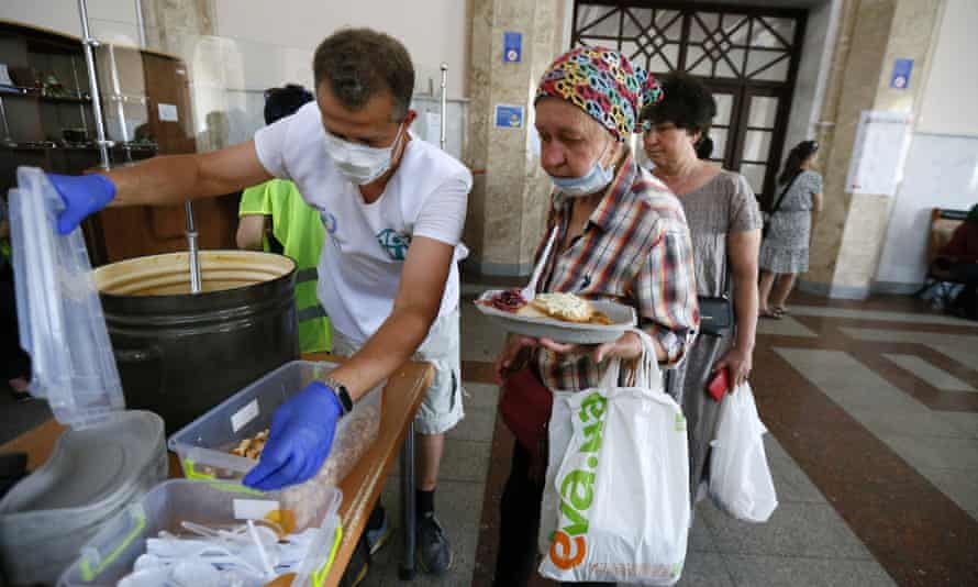 Refugees from Mykolaiv get food and aid after their evacuation at the railway station in Odesa, Ukraine.