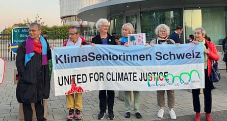 A line of women holding a sign saying: ‘United for climate justice.’