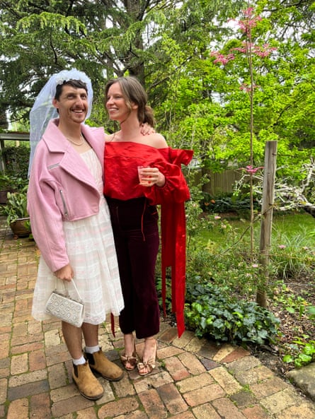 The moment I knew: it was so embarrassing, I didn't know what to do. So I said, 'Are we going to kiss now?' | australian way of life 1 A man in a wedding veil, white dress, pink jacket and boots, standing with a woman in a red blouse and black pants