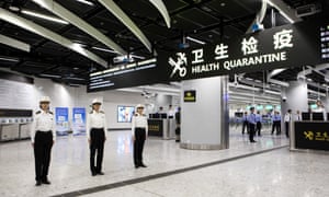 Officers stand in the Mainland Port Area at West Kowloon station.