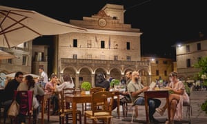 Outdoor tables of a restaurant in the main square of the medieval town of Montefalco.