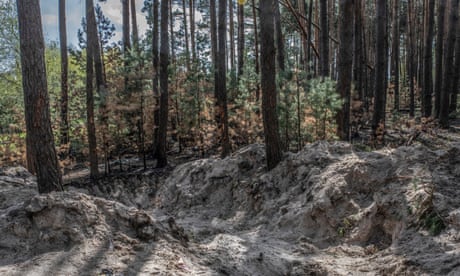 Mass grave where the bodies of Motyzhyn's village head, Olga Petrivna, her son and one other person were found