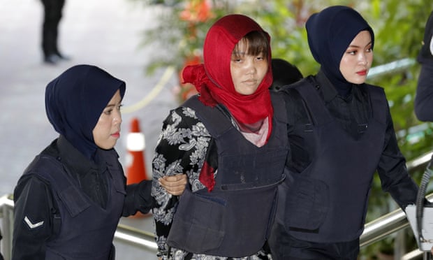 Vietnamese Doan Thi Huong is escorted to court in Shah Alam, Malaysia, on Thursday to face trial over the murder of Kim Jong-nam.