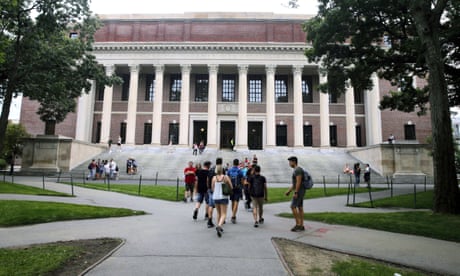 FILE - Students walk near the Widener Library at Harvard University in Cambridge, Mass., Aug. 13, 2019. Harvard University is telling students to take classes from home for three weeks, with a return to campus scheduled for late January, conditions permitting. (AP Photo/Charles Krupa, File)