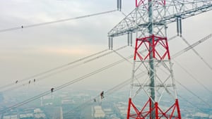 Wuxi City, China. Workers check the cables on the world’s highest transmission tower