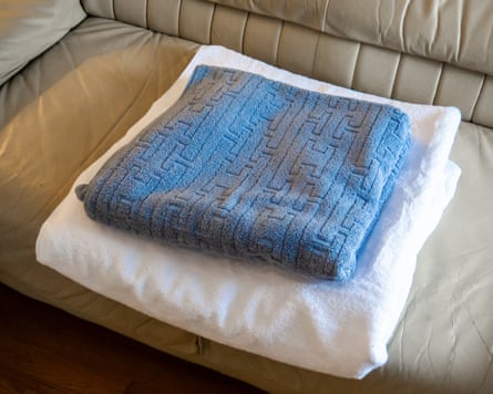 An American Soft Linen Oversized Bath Sheet with a regular bath towel on top of it