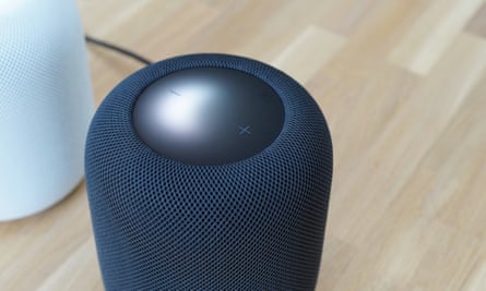 Apple HomePod with its top panel lighting up.