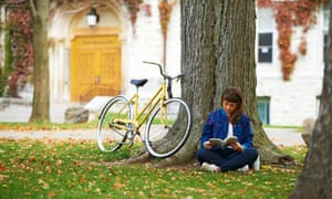 woman reading book under tree