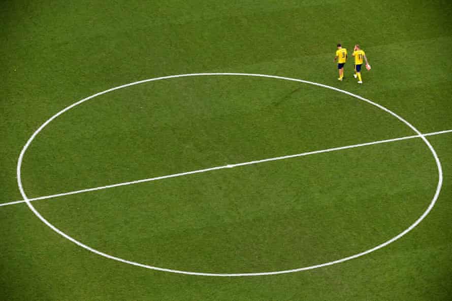 Sweden’s John Guidetti and Victor Lindelof walk of the pitch dejected.