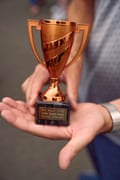 A man’s hands holding a trophy engraved with “ RNC Rally – 6.7.25 Wythall Transport Museum Class Winner