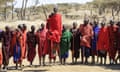 Maasai warriors wearing brightly coloured clothing perform traditional dance, Ngorongoro Crater Conservation Area Tanzania