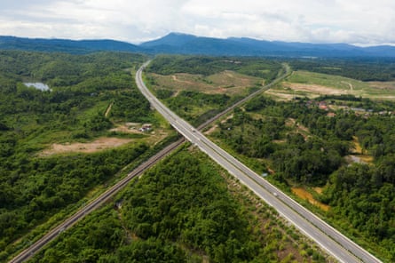 A highway crosses over train tracks near Phonhong in Laos