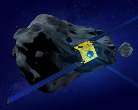 A yellow box with a large lens and two solar-panelled wings nears a large pitted rock in a dark blue sky