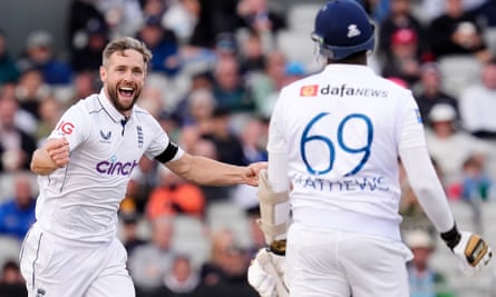 England’s Chris Woakes celebrates taking the wicket of Sri Lanka’s Angelo Mathews, who had earlier been dropped off Matthew Potts.