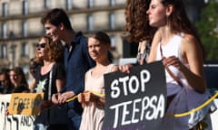 FRANCE-ENVIRONMENT-CLIMATE-POLITICS-DEMO<br>Swedish climate activist Greta Thunberg (C) and a protester holding a placard which reads "Stop TEEPSA" (TotalEnergies EP South Afica) take part in a demonstration against fossil fuels and for climate at Place de la Republique on the sidelines of the New Global Financial Pact Summit, in Paris, on June 23, 2023. (Photo by Thomas SAMSON / AFP) (Photo by THOMAS SAMSON/AFP via Getty Images)