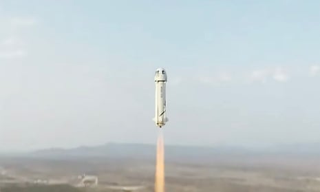 The New Shepard rocket, with its rounded top and long, slim shaft, takes off on Tuesday.