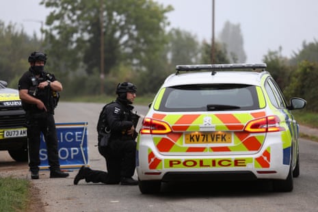 Police officers guard an area as roadblocks remain in place near the RAF Fairford airbase.