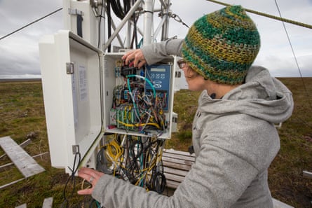 Scientist Roxane Andersen checks the electronics of an eddy flux tower, an instrument that measures the level of CO2 in the air flowing over the bog in the Forsinard Flows reserve