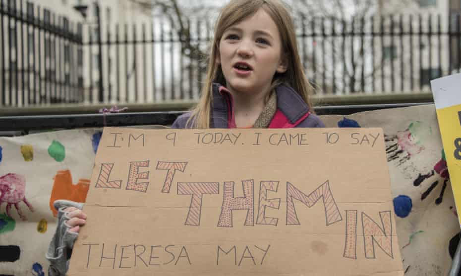 A girl takes part in a protest outside Downing Street to call for Britain to accept more refugee children.