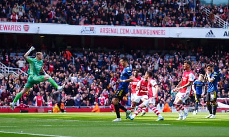 Arsenal goalkeeper Aaron Ramsdale celebrates after Bruno Fernandes of Manchester United hit the post with his penalty.