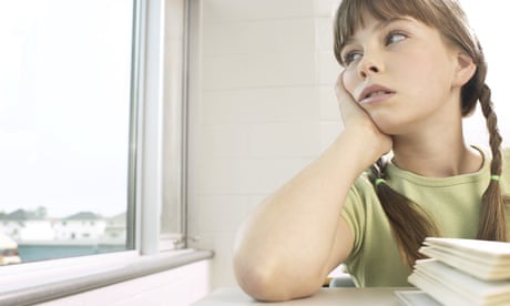 Little girl daydreaming out of classroom window. Photograph: Alamy