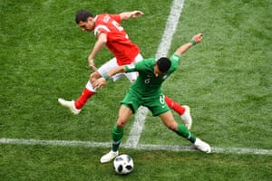 Russia’s Andrey Semenov, left, and Saudi Arabia’s Mohammed Al-Breik tussle for the ball