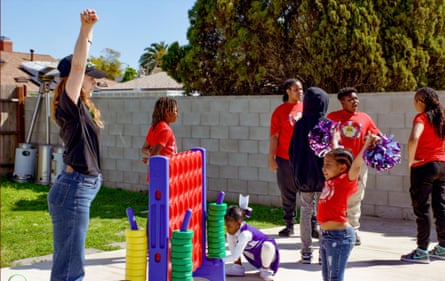 Kids and adults playing outdoor crippled of Connect Four.