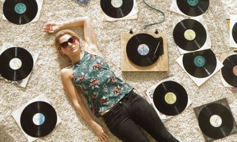 Woman on floor surrounded by records