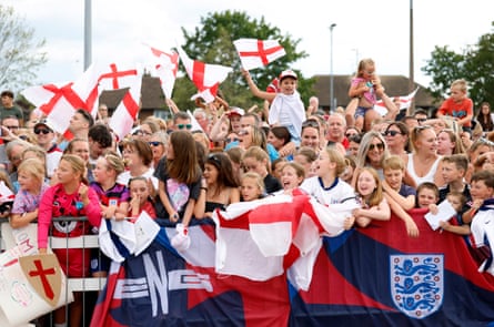 A crowd of fans wave England flags
