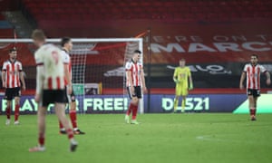 John Egan and other Sheffield United players react after Jamie Vardy put Leicester 2-0 up