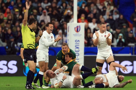 New Zealand referee Ben O'Keeffe (let) awards a penalty to England.