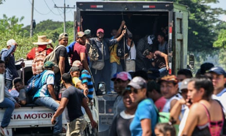 Hondurans head towards the US from San Pedro Sula in vans and trucks on 13 October.