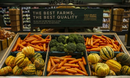 Pumpkins, carrots and broccoli on sale in the fresh food section of a Marks &amp; Spencer store.