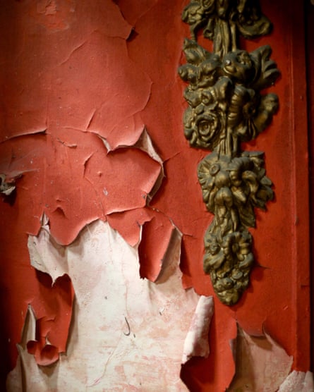 Peeling red paint and a gold rococco feature