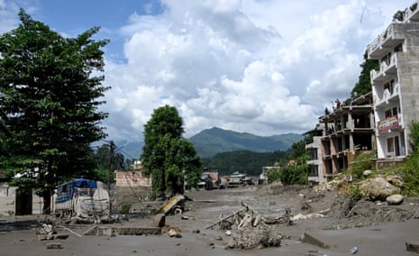 Houses and trucks lie deluged in sludge after flash floods at Trishuli Bazar in Nepal’s Nuwakot district on 26 August 2026.