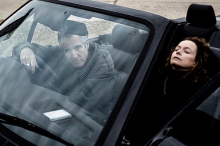 Samantha Morton and Richard Russell sit in a car, Russell leaning on the steering wheel, Morton lying back in her seat