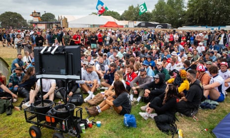 England fans watching the match against Slovakia on a small TV screen at Glastonbury.