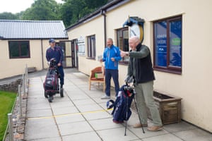 Vic Marks and his playing partner, Gavin, are greeted at the club house.