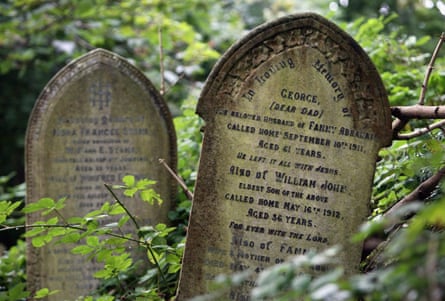 Ivy and other plants grow over the gravestones at Arnos Vale Cemetery in Bristol, England.