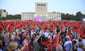 Supporters of the Socialist party wave Albanian national flags during the closing electoral rally in Mother Theresa square in Tirana