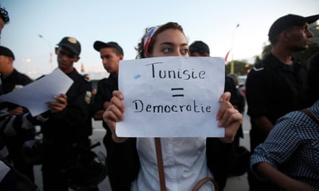 A Tunisian demonstrator holds a sign during a protest against the Islamist Ennahda movement in Tunis October 26, 2011. 