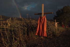 Red dresses hung on crosses along a roadside commemorate children who died at the Kamloops Indian Residential School, an institution created to assimilate Indigenous children, following the detection of as many as 215 unmarked graves in Kamloops, British Columbia