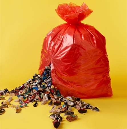 Red bin bag against yellow background, with trainers bursting out of it