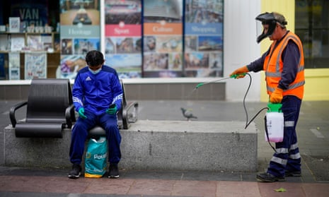 A council worker disinfects street furniture in Leicester.