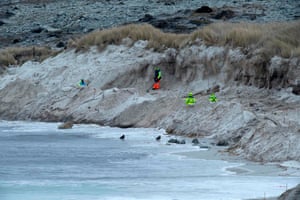 Zimbabweans work on a mined beach in Stanley