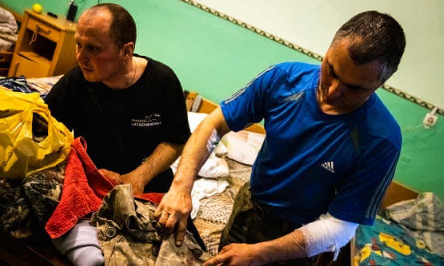 Serhiy (left) and Gennadiy talk about their time in battle.